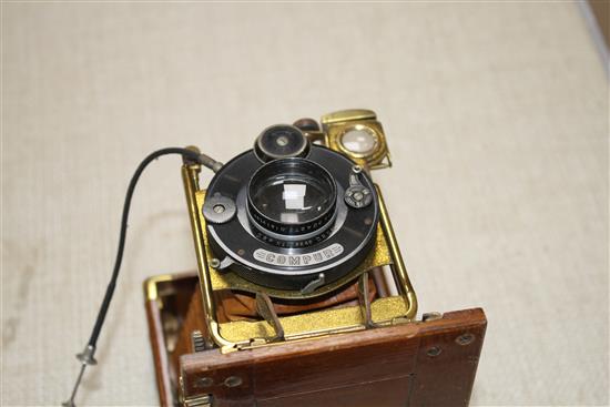 A Compur Tropical cased camera with Dialytar lens and gilt brass mounted teak case, height 18cm, depth when closed 6cm, length when